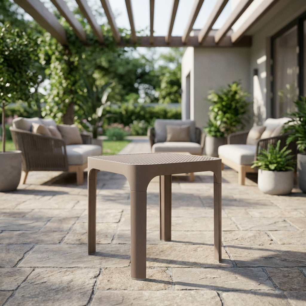 Generate a cinematic product shot of the 'Out door side table Net Tor 40"' positioned in a stylish outdoor patio scene. Use HDR studio lighting combined with diffused daylight effects to enhance the matte finish of the fibreglass and polypropylene resin. P