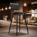 Capture a high-resolution image of the Aviator Bar Stool in a stylish modern bar setting, illuminated with softbox studio lighting that accentuates the sleek black powder-coated finish and vintage retro accents. Use a low-angle shot with a 50mm focal lengt
