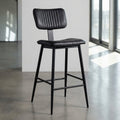 Present the Aviator Bar Stool in a minimalist, well-lit showroom environment using HDR studio lighting to bring out the rich texture of the black powder coating and the durable construction. The shot is a slightly elevated, close-up profile with a 35mm len