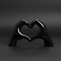 A highly detailed, studio-shot image of the 'Heart in hand black' sculpture, illuminated by a softbox lighting setup that emphasizes the glossy, polished resin surface. The camera is positioned at a 45-degree angle with a macro lens at 100mm focal length, 