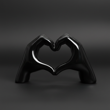 A highly detailed, studio-shot image of the 'Heart in hand black' sculpture, illuminated by a softbox lighting setup that emphasizes the glossy, polished resin surface. The camera is positioned at a 45-degree angle with a macro lens at 100mm focal length, 