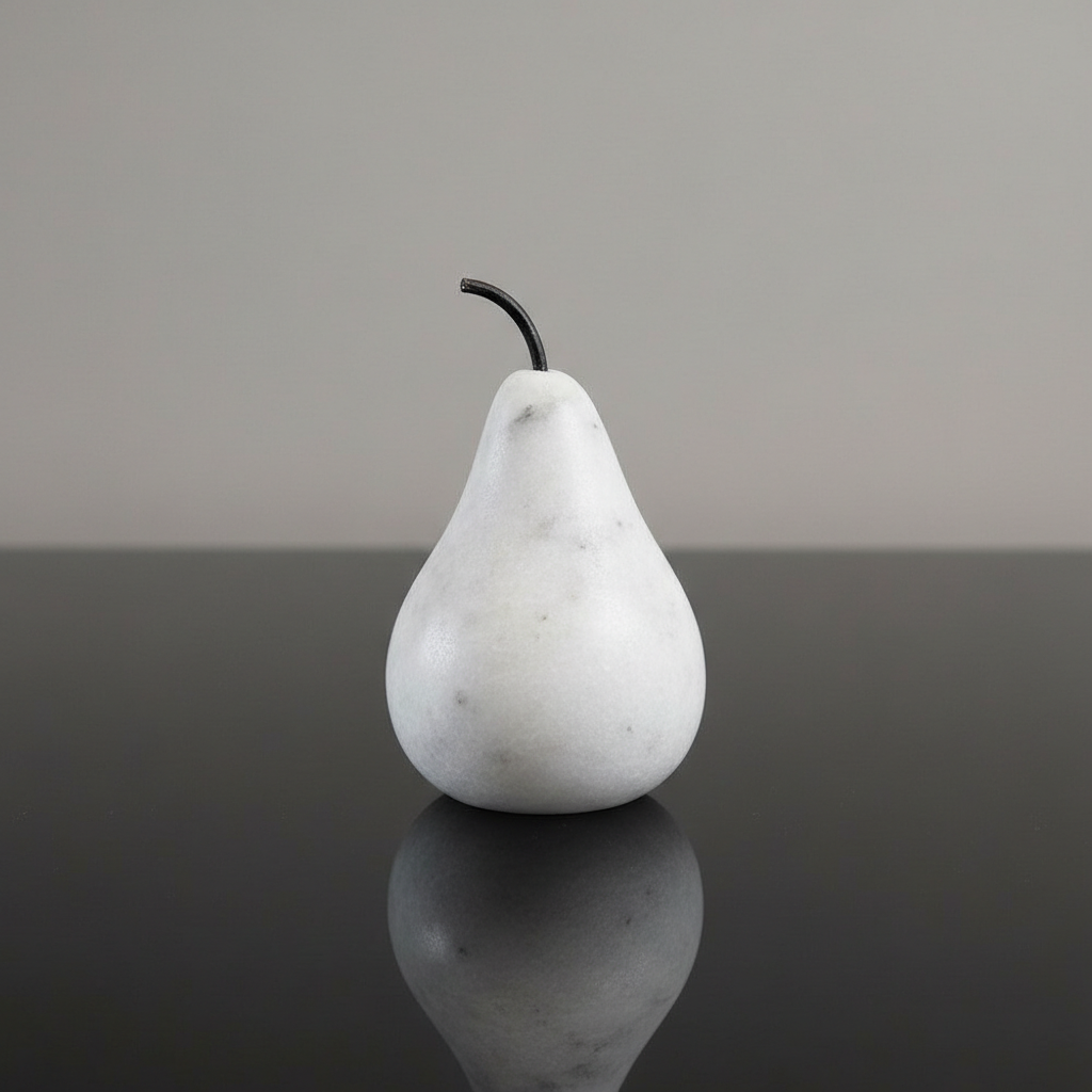 Capture a close-up studio shot of the 'Marble Pear - small' on a reflective black glass surface under softbox lighting to emphasize its smooth, polished marble texture. Use a macro lens at 100mm focal length with a shallow depth of field to focus sharply o
