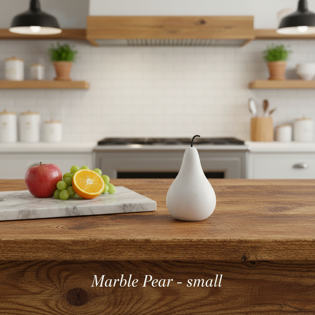 Create a lifestyle scene featuring the 'Marble Pear - small' elegantly placed on a rustic wooden kitchen countertop next to a marble cutting board and some fresh fruit, under warm HDR studio lighting to evoke a cozy, inviting atmosphere. Capture the scene 