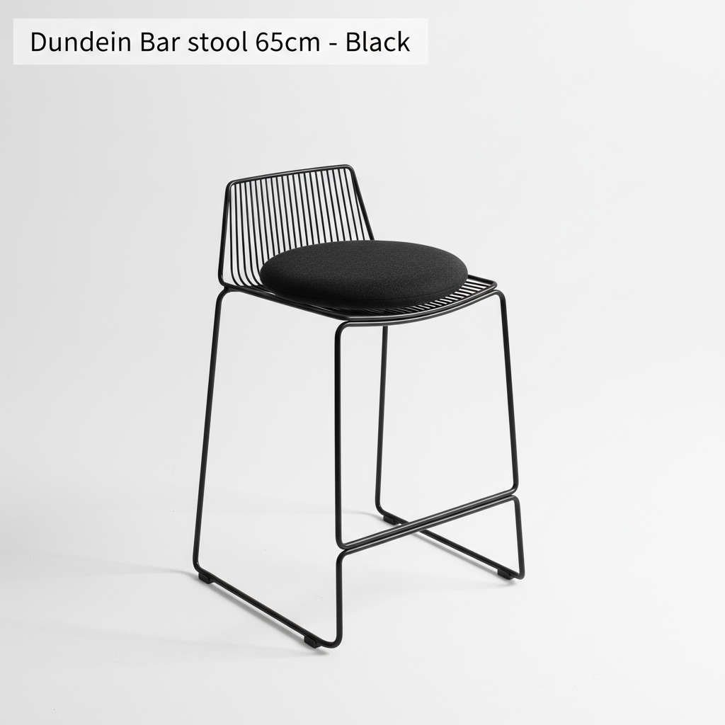 A luxurious lifestyle shot of the Dunedin Bar Stool in a chic modern kitchen setting with warm, natural lighting complemented by HDR studio lights to enhance the texture of the felted wool cushion and metallic wire frame. The camera is positioned at a slig