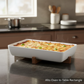 Construct a cinematic, lifestyle-oriented scene featuring the Alto Oven to Table Rectangle dish styled on a sleek, modern kitchen counter with natural diffused daylight from a nearby window. Capture the shot at eye level with a 35mm lens to give a balanced