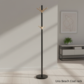 Create a high-resolution, cinematic studio shot of the Uno Beach Coat rack, positioned in a modern entrance hallway with soft, diffused daylight streaming in. Use a slight top-angle perspective with a 50mm lens on a DSLR camera, capturing intricate details