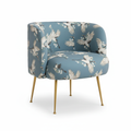 A sophisticated product shot of the Cloe Crane bird print chair, captured in a bright, contemporary studio setting with diffused daylight. The scene features soft, HDR studio lighting highlighting the plush velvet fabric with intricate bird print details, 