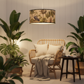 Design a cinematic scene featuring the 'Bamboo Lampshade - Cranes' as the centerpiece suspended above a cozy, tropical-themed reading nook illuminated by HDR studio lighting. Use a camera angle from below, with a 35mm focal length to emphasize the detailed