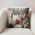 A luxurious studio shot of the 'Sari Printed Cushion - In Bloom' placed centrally on a plush, neutral-toned armchair, captured with a softbox lighting setup that highlights the rich colors of the floral print. The camera uses a 50mm lens at a close-up angl