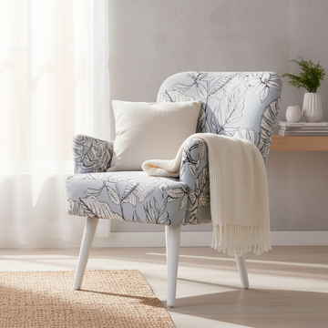 Present the Noja Velvet Arm Chair Liscie Print within a cozy, modern Scandinavian-inspired living space. Utilize HDR studio lighting to create a bright, inviting atmosphere, with diffused daylight streaming in from large windows. The camera captures the sc