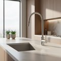 A cinematic lifestyle scene showcasing the Mercer SS pull out gooseneck mixer AM011 installed in a luxurious modern kitchen. The shot is captured from a side angle with a 35mm lens, emphasizing the gooseneck's graceful curve and pull-out feature. The stain