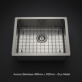 A highly detailed studio shot of the Aurora Stainless 400mm x 500mm sink in gun metal finish, captured with a macro lens using a 100mm focal length for sharpness and clarity. The sink is positioned centrally against a sleek, matte black seamless background