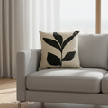 A highly detailed, cinematic close-up shot of the 'Cushion Prints - Leaf' placed on a modern, minimalist sofa in a bright, airy living room. The scene is lit with softbox lighting to emphasize the vivid green and leaf print pattern on the cushion’s texture