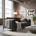 Create a stylish lifestyle scene featuring the Tyson 3 Seater Sofa in a contemporary loft setting. The sofa, upholstered in Boston Black, is photographed from a front three-quarter view with a Canon RF 50mm lens, medium aperture to create a shallow depth o